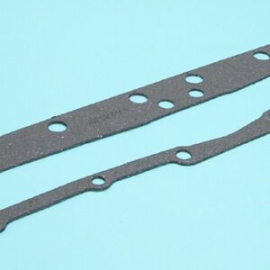 A pair of gaskets are laying on the ground.