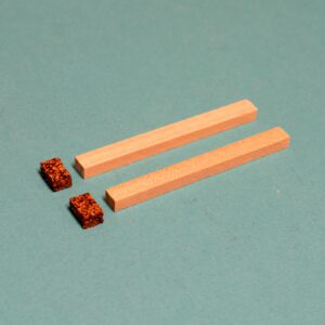 Two wooden sticks with cork on top of them. Studebaker