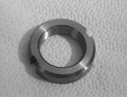 A black and white photo of a 1925-1931CHEVROLET REAR AXLE BEARING RETAINER NUT.