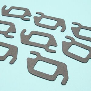 A group of eight pieces of metal that are cut out.