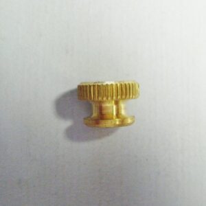 A large brass nut 8/32 for buzz coils on a white surface.