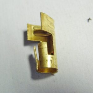 A Better distributor cap or coil terminal on a white surface.