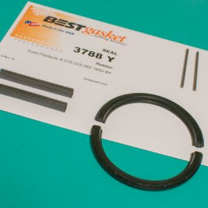 A black ring and a piece of paper on a table.