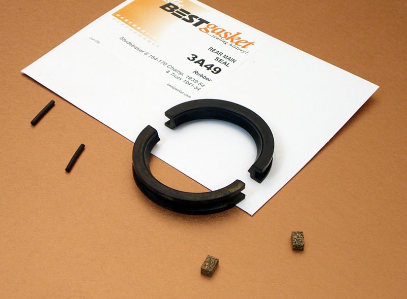 A black rubber ring and a piece of paper on a table.