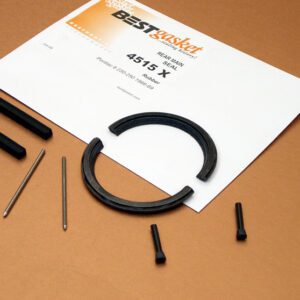 A black ring with a screw and a piece of paper.