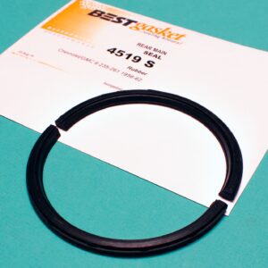 A black rubber ring on top of a piece of paper.