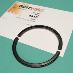 A black piston ring on top of a piece of paper.