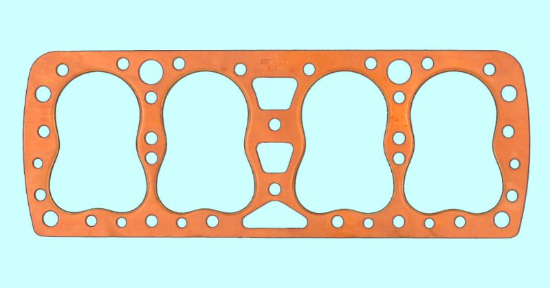 A gasket with four holes on it.
