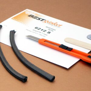 A pair of scissors and a piece of paper on a table.