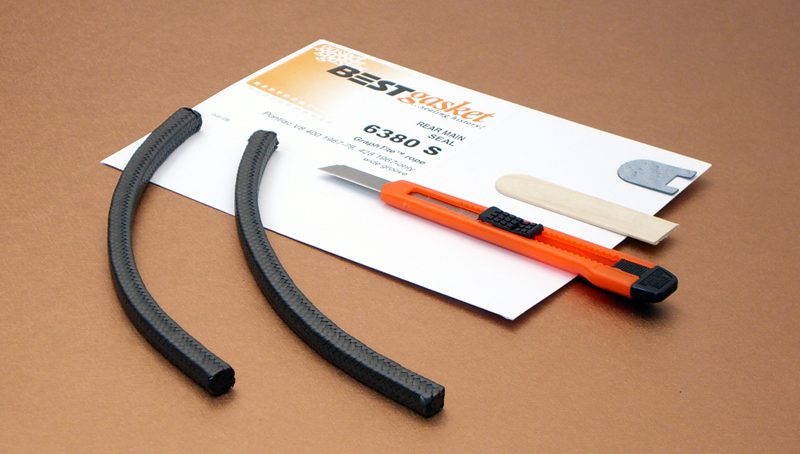 A pair of scissors and a piece of paper on a table.