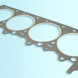 A cylinder head gasket on a blue background.