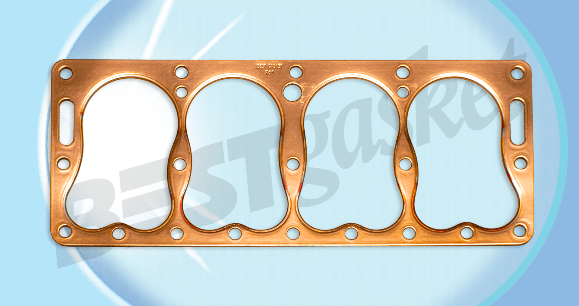A copper gasket with four holes on it.