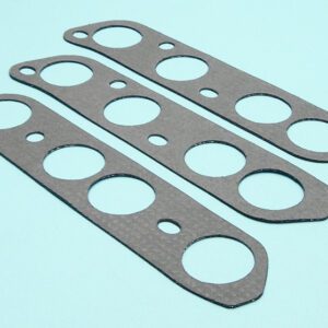 A set of four gaskets on a blue surface.