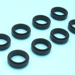 A set of six black rubber seals on a blue surface.