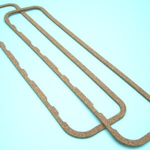 A pair of brown gaskets on a blue surface.